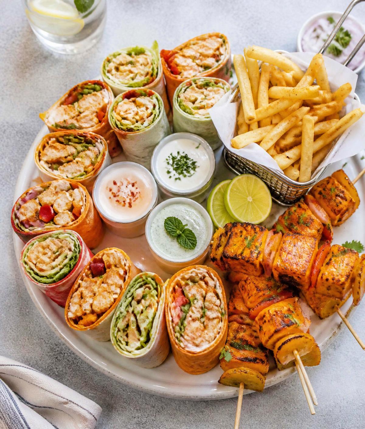 Wrapafella party platter with wraps, dips, fries and paneer tikka skewers